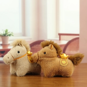 Cute plush horse mascot keychains with gold ingots on a wooden surface in warm lighting