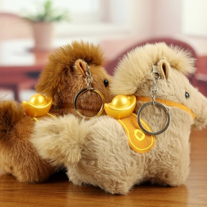 Detail of plush zodiac horse keychains in brown and beige with golden ingot accents