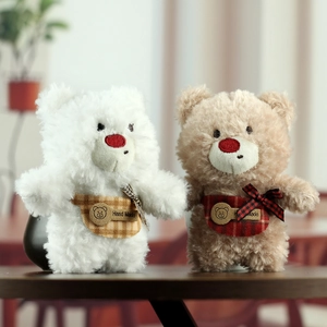 Cute white and brown plush teddy bear dolls with handmade plaid bibs and soft fur texture