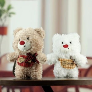 Detail of plush teddy bears with red noses, plaid scarves and handmade tags