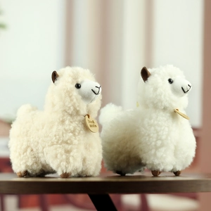Set of two soft alpaca plush keychains in white and beige with handmade wooden tags