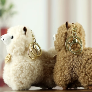 Detailed close-up of soft alpaca plush keychains with premium gold metal hardware and hooks