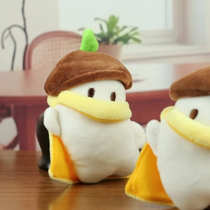 Close-up of cute long-tailed tit plush doll with brown knit hat and a yellow cape