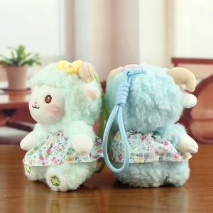 Close-up of cute plush sheep keychains in light green and blue floral dresses