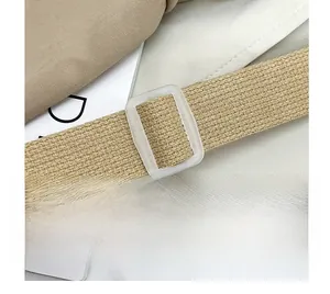 Detail of adjustable thick woven shoulder strap with a translucent frosted buckle