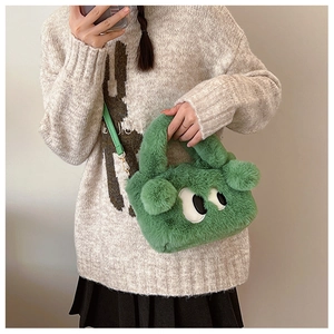 Détail du sac en peluche verte avec de grands yeux de dessin animé et texture douce