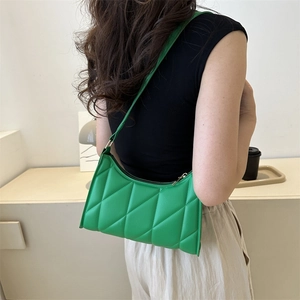 Quilted green faux leather underarm bag shown on model with chic rhombic stitching