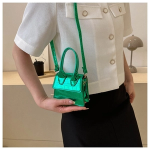 Close-up of a mini emerald green crossbody bag with crocodile pattern and metallic finish
