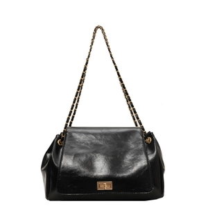 Retro black leather shoulder bag with vintage gold turn-lock and chain strap on white background