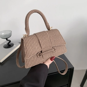 Fashionable woven crossbody bag in khaki featuring a top handle and adjustable shoulder strap