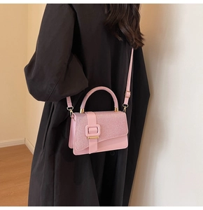 Detail of pink vintage square bag with glitter texture and smooth leather texture