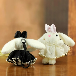 Cute plush bunny pendants in black and white with pearls, ribbons and soft faux fur