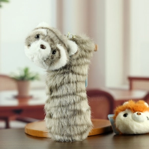 Detail view of the soft striped red panda plush pendant with a golden metal keychain hook