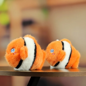 Macro shot of two orange plush clownfish toys with soft fur texture and blue eyes