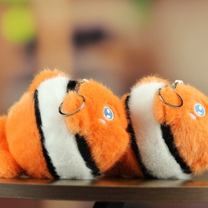 Detail of plush clownfish keychain with soft orange stripes and silver metal ring