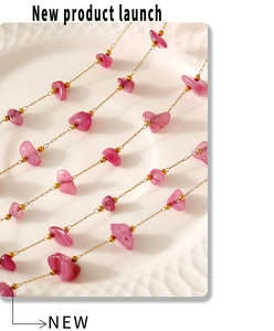 Close-up of bohemian pink natural stone beads on a delicate gold stainless steel chain