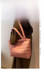 Close-up of pink quilted puffer tote bag featuring square stitching and magnetic clasp