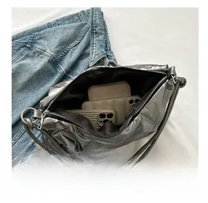 Interior view showing large storage capacity of the silver quilted puffer shoulder bag