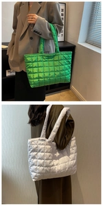 Detail of large quilted puffy tote bags in vibrant green and white with soft padding