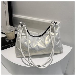 Detailed close-up of iridescent silver quilted cloud bag featuring metallic ring handle