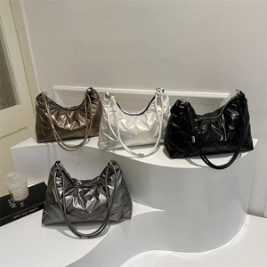 Quilted puffer tote bags in metallic colors with thick rope straps on display