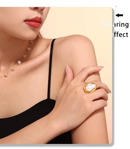 Baroque irregular pearl ring with gold-plated textured frame on model finger