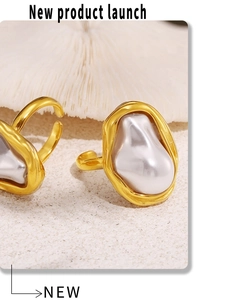 Macro shot of irregular baroque pearl set in a gold-plated hammered texture ring