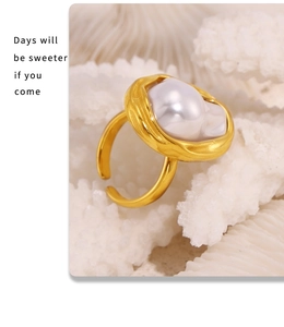 Detail of baroque pearl ring with liquid metal gold band on white coral stone