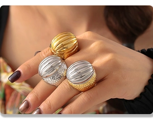 Macro shot of vintage titanium steel rings with vertical ribbed texture and gold finish