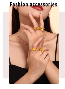 Close-up of polished 18k gold plated geometric rings stacked on model fingers
