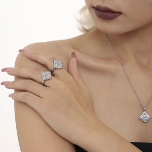 Evil eye jewelry set with 18K gold plated square pendants and rings on a model