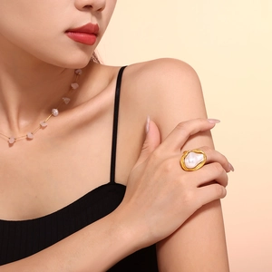 Baroque style gold-plated ring with irregular pearl on a model's finger