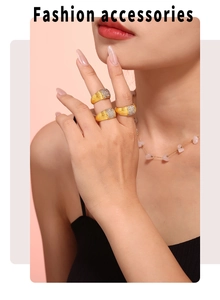 Detail of gold godron rings set with zircon and pink stone necklace on a model