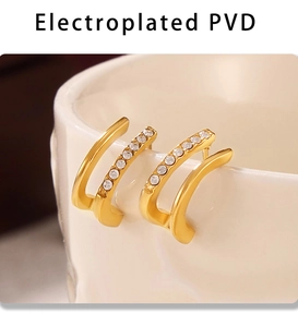 Détail de boucles d'oreilles C double couche en or PVD avec des rangées de zircones
