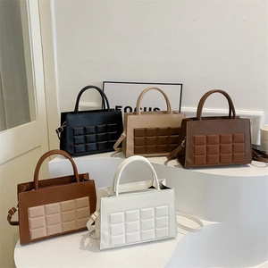 Quilted tote bags in five colors on a white display stand for 2025 winter fashion