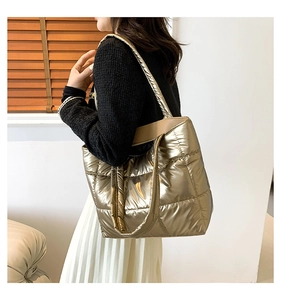Sac fourre-tout matelassé doré métallisé porté par un mannequin pour illustrer sa taille