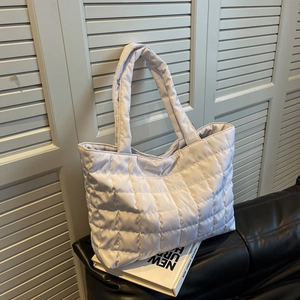 Chic lavender quilted down tote bag with a soft puffy texture and shoulder strap