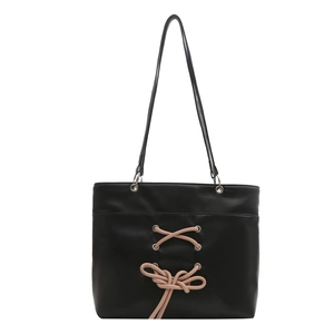 Sac cabas en cuir noir avec rubans roses croisés pour un look balletcore tendance