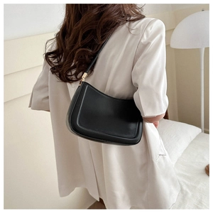 Minimalist black leather underarm bag for women with matte finish and metal buckle
