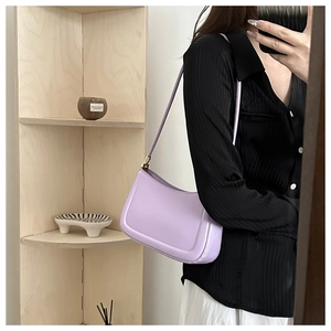 Close-up of a lavender leather underarm bag featuring smooth texture and precise stitching