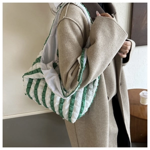 Detailed close-up of green and white striped tote bag with unique seersucker texture