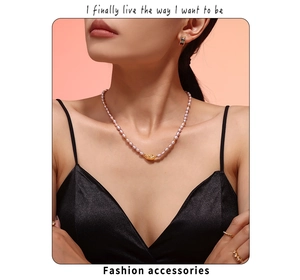 Detail of pink freshwater pearl necklace with gold-tone accent on female model