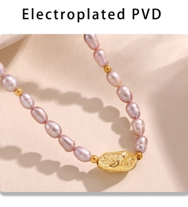 Macro detail of natural pink-purple pearls with irregular lava-textured gold-plated charm