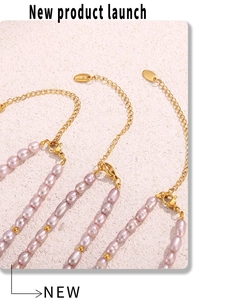 Detail of pink baroque pearls on a gold stainless steel necklace with lobster clasp