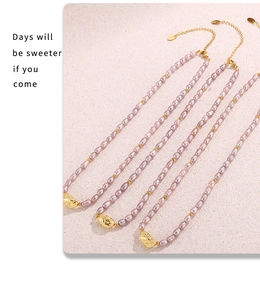 Macro view of lavender freshwater pearl necklaces with gold hammered metal pendants
