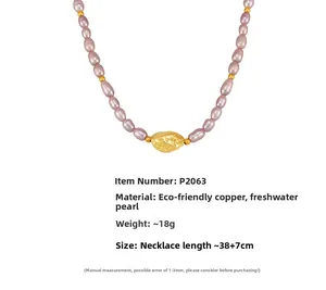 Close-up of pink freshwater pearl necklace with textured gold pendant on white background