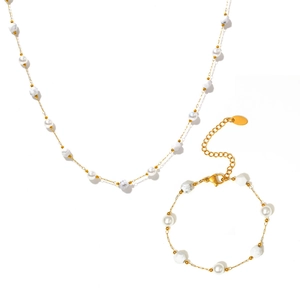 Elegante gouden sieradenset met imitatieparels en kralen met marmertextuur