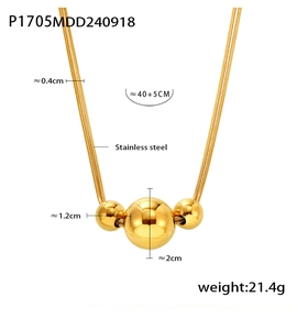 Detail of gold double-layered snake chain necklace with three polished spheres