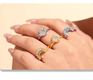 Detailed view of stacked sun and moon rings set with zircon on hand