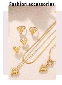 Macro view of gold plated heart jewelry set featuring white pearls and sleek snake chain